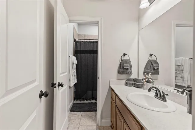 a bathroom with a sink and mirror with toilet