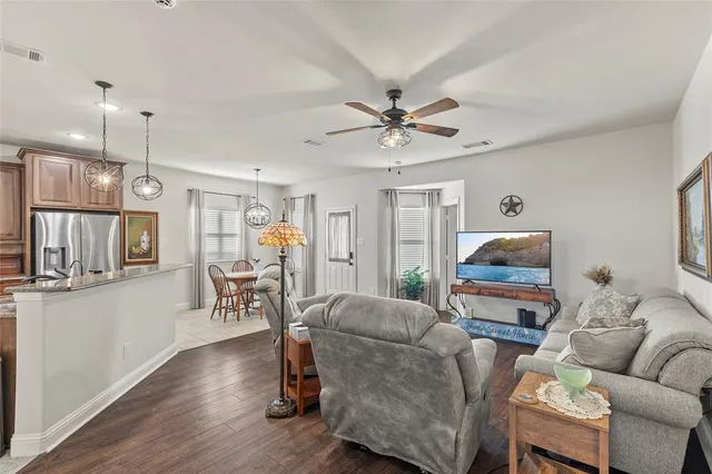 a living room with furniture and wooden floor