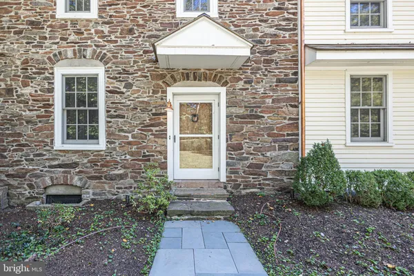 a bed sitting in a bedroom next to a window with a fireplace
