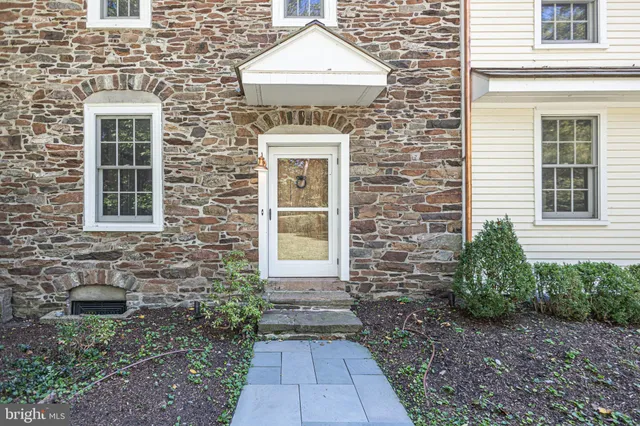 a bed sitting in a bedroom next to a window with a fireplace