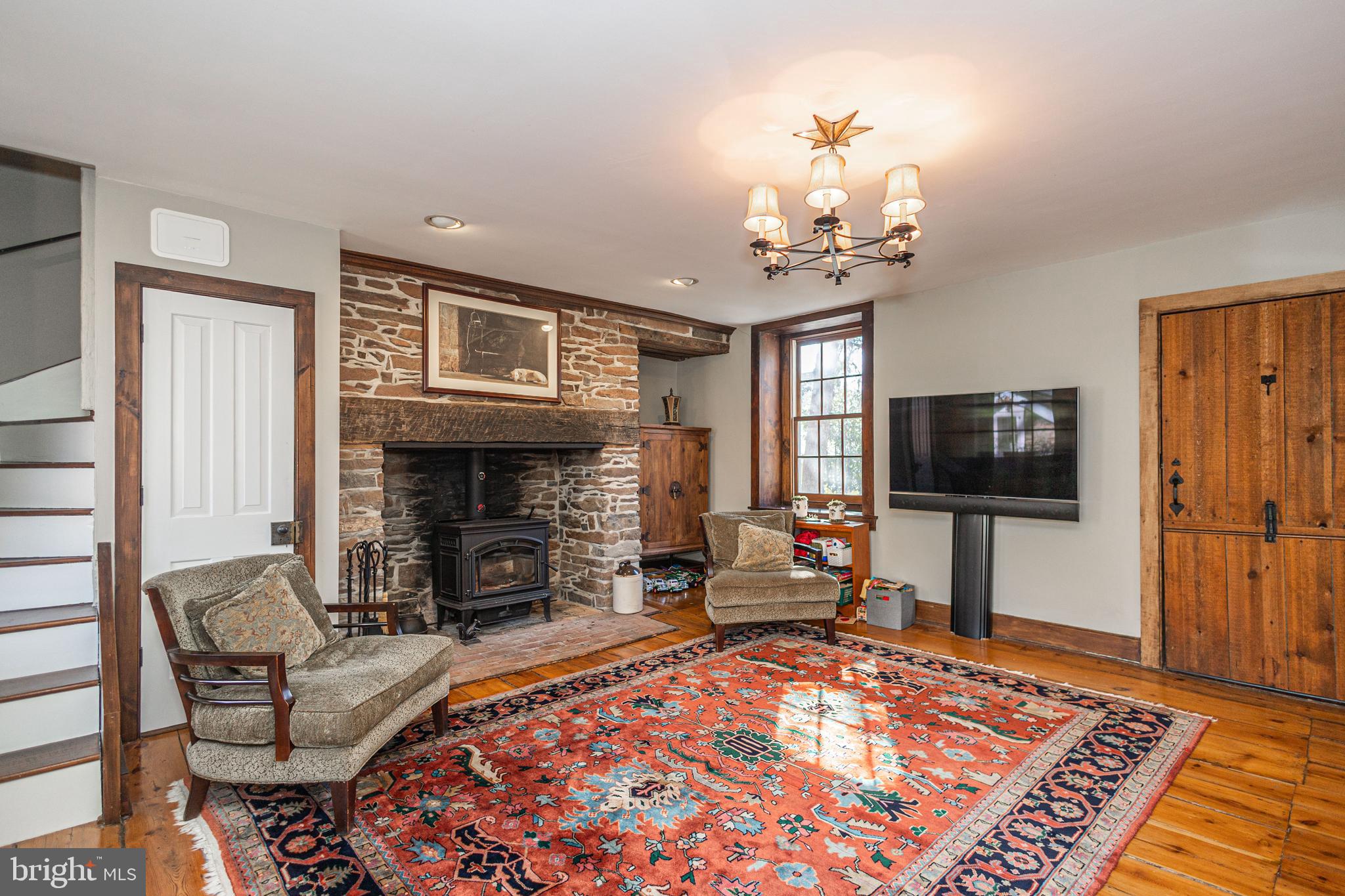 928 Taylorsville Road Washington Crossing, PA 18977 - Photo 17 of 106 a living room with furniture a flat screen tv and a fireplace