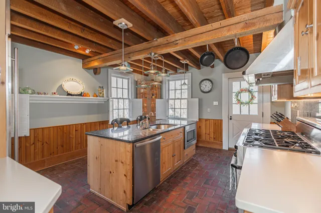 a open kitchen with stainless steel appliances granite countertop a stove and cabinets