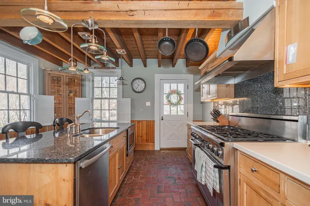 a kitchen with stainless steel appliances granite countertop lots of counter top space