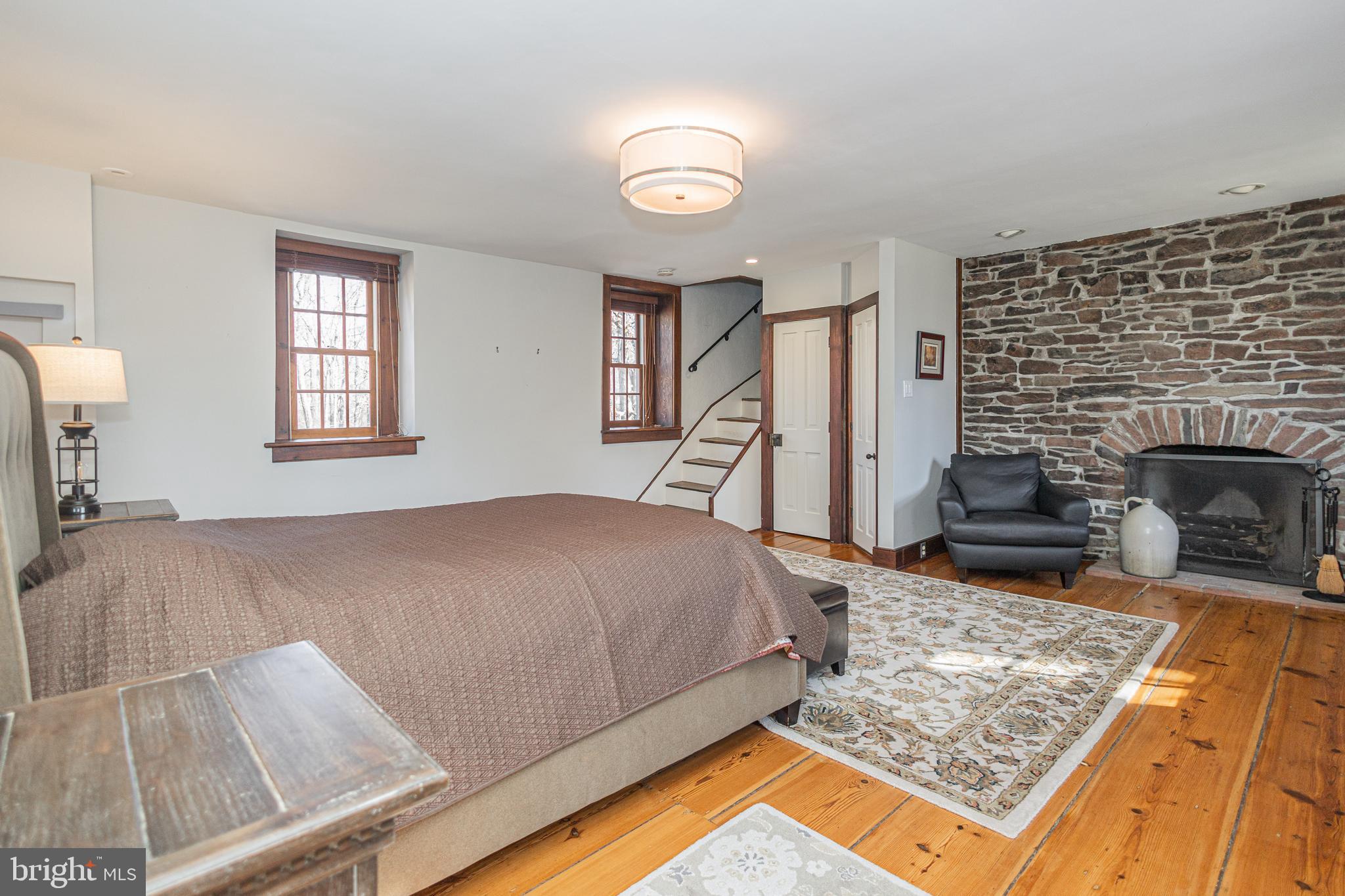 928 Taylorsville Road Washington Crossing, PA 18977 - Photo 25 of 106 a bed sitting in a bedroom next to a window with a fireplace