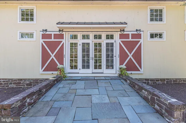a view of a swimming pool with lawn chairs under an umbrella