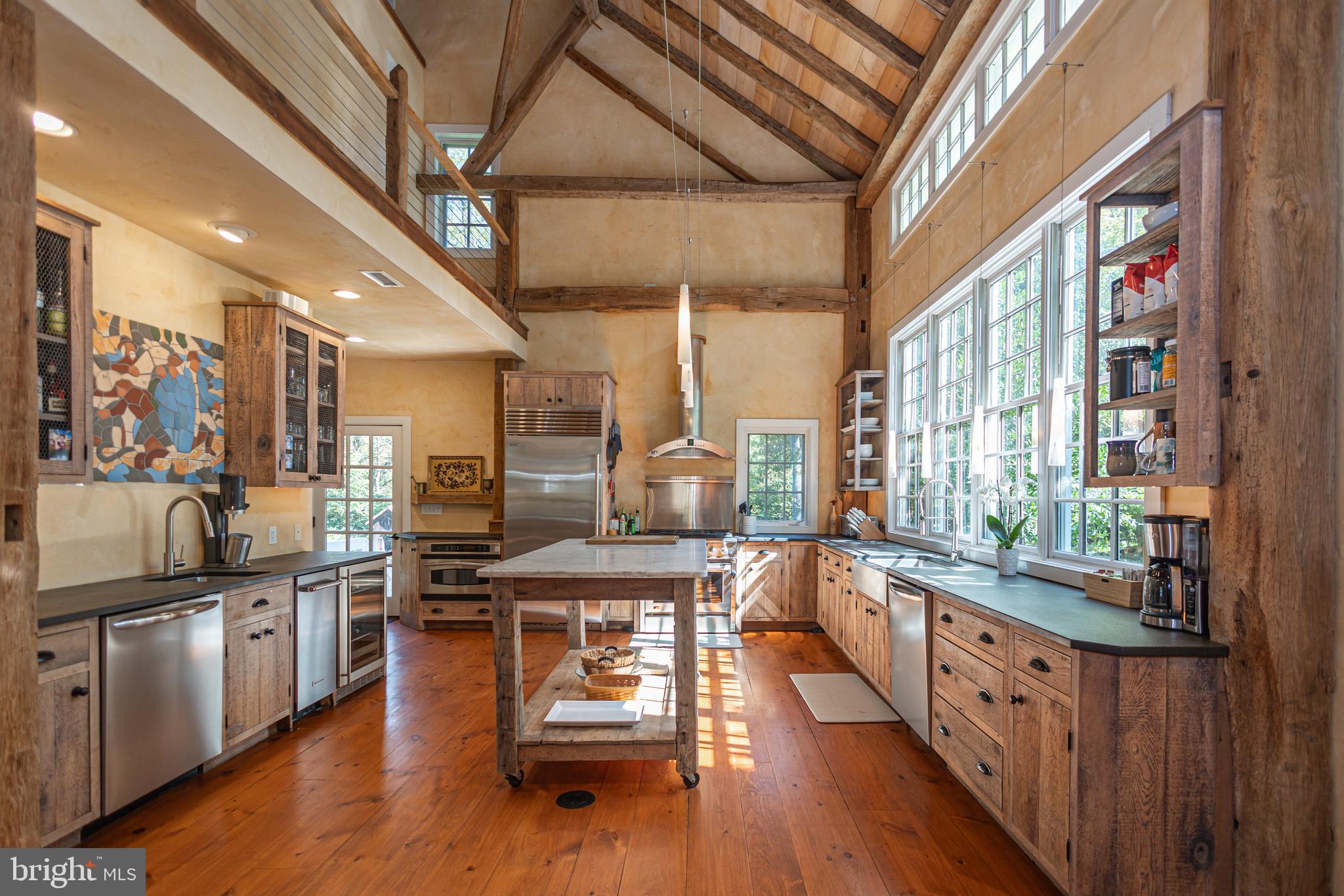 928 Taylorsville Road Washington Crossing, PA 18977 - Photo 37 of 106 a kitchen with stainless steel appliances granite countertop lots of counter top space and wooden floors