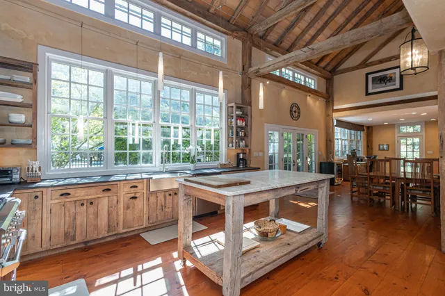 a view of a patio with a table chairs and a fire pit
