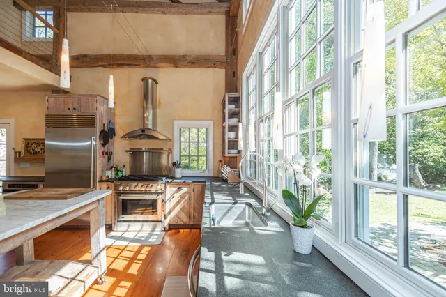 an aerial view of residential house with outdoor space and trees all around