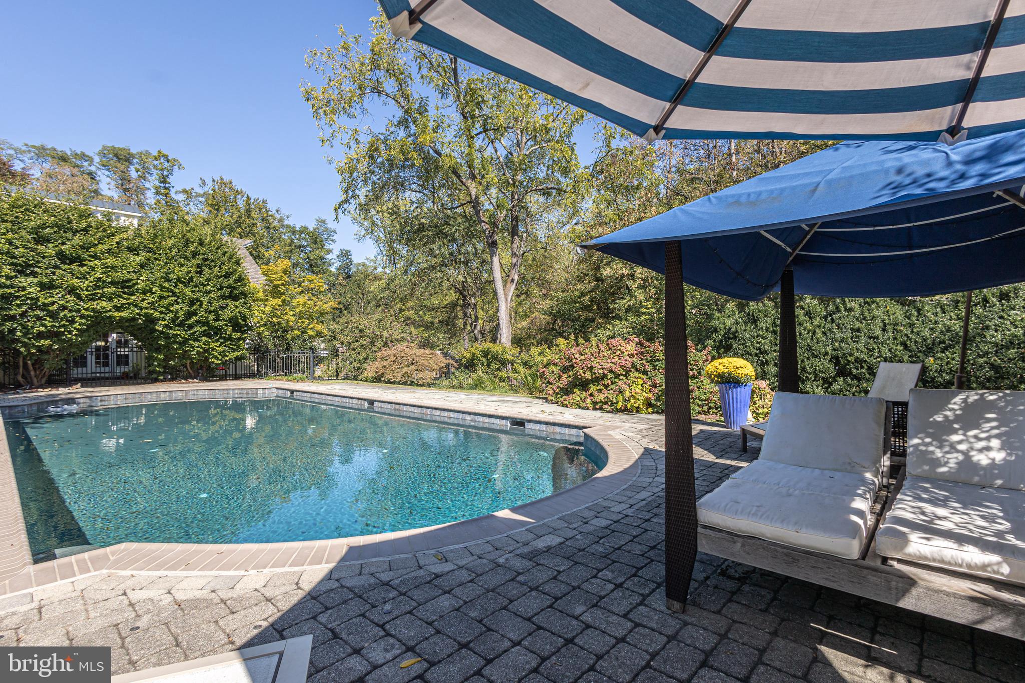 928 Taylorsville Road Washington Crossing, PA 18977 - Photo 83 of 106 a view of a patio with table and chairs under an umbrella