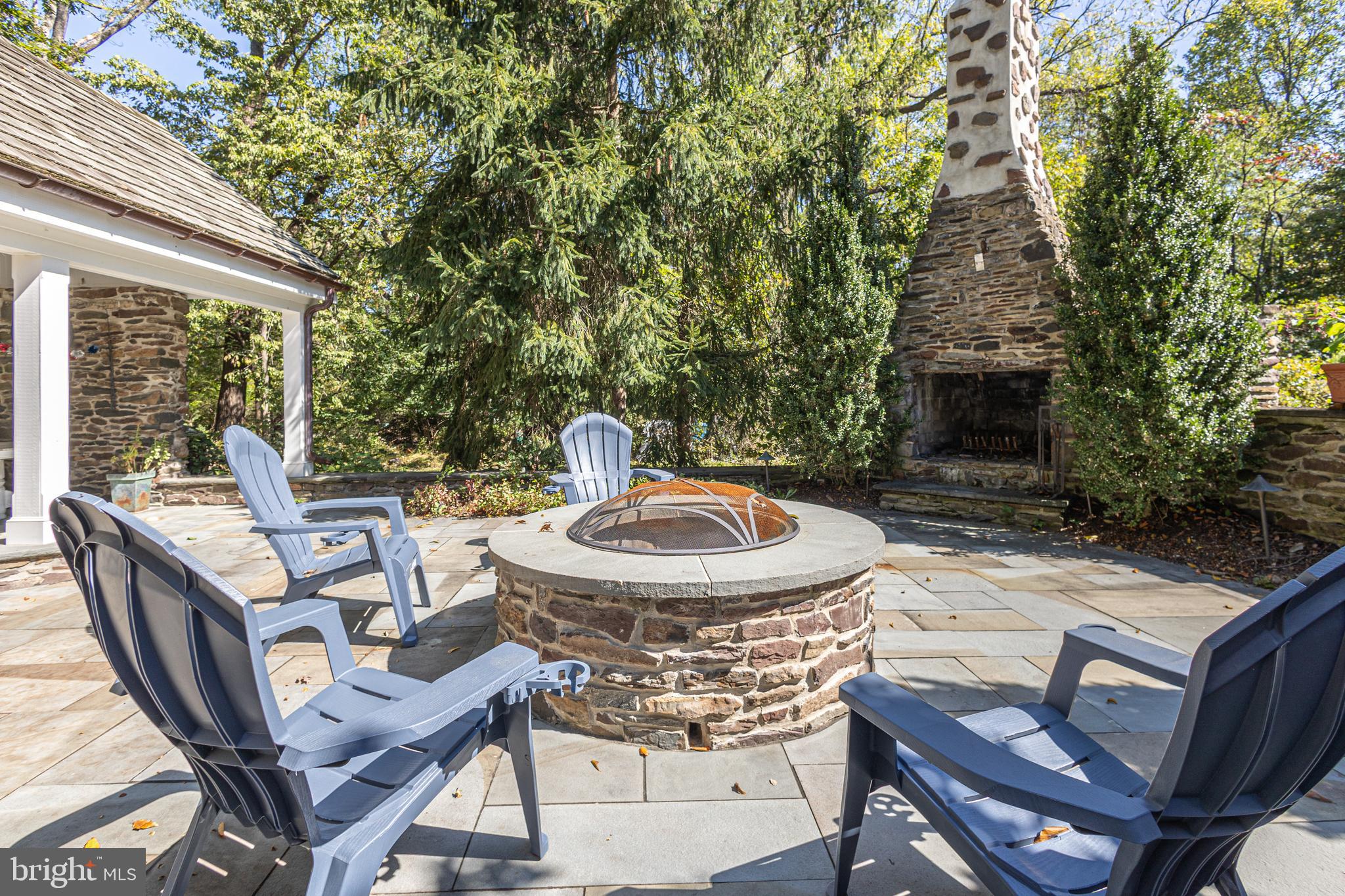 928 Taylorsville Road Washington Crossing, PA 18977 - Photo 92 of 106 a view of a patio with a table chairs and a fire pit