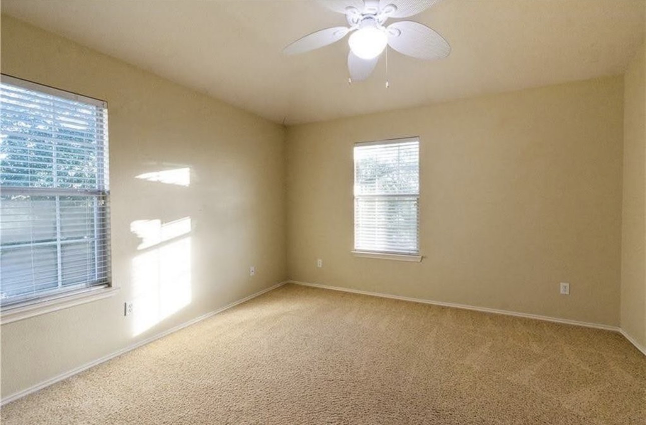 1900 Scofield Ridge Parkway, Unit 3101 Austin, TX 78727 - Photo 17 of 24 Carpeted room featuring two windows with horizontal blinds and a ceiling fan with integrated lighting