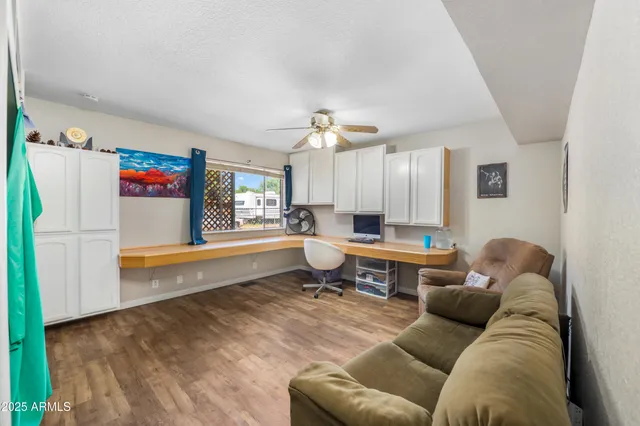 a living room with furniture rug and a window