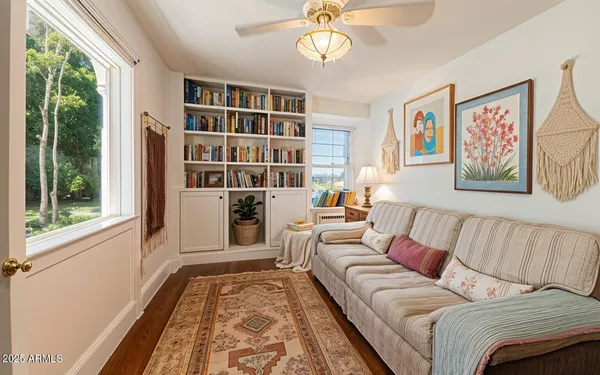 a living room with furniture and a book shelf