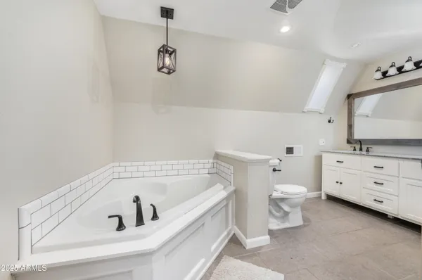 a bathroom with a bathtub sink and toilet