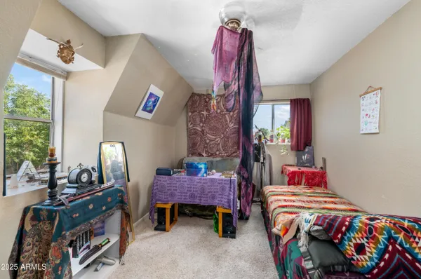 a bedroom with two beds and a chandelier