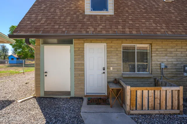 a view of swimming pool with trees and wooden fence
