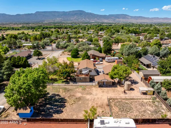 an aerial view of a city with lots of residential buildings ocean and mountain view in back