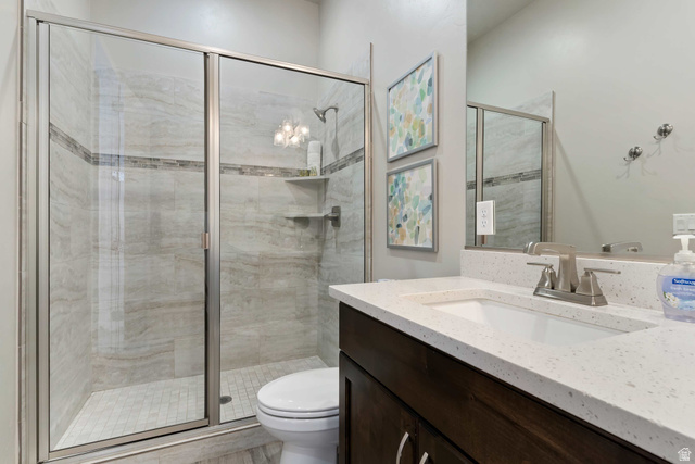 2600 Ocotillo Way, Unit 31 Santa Clara, UT 84765 - Photo 23 of 73 Shower enclosure with glass panels, light-toned tile walls, and a decorative accent tile band