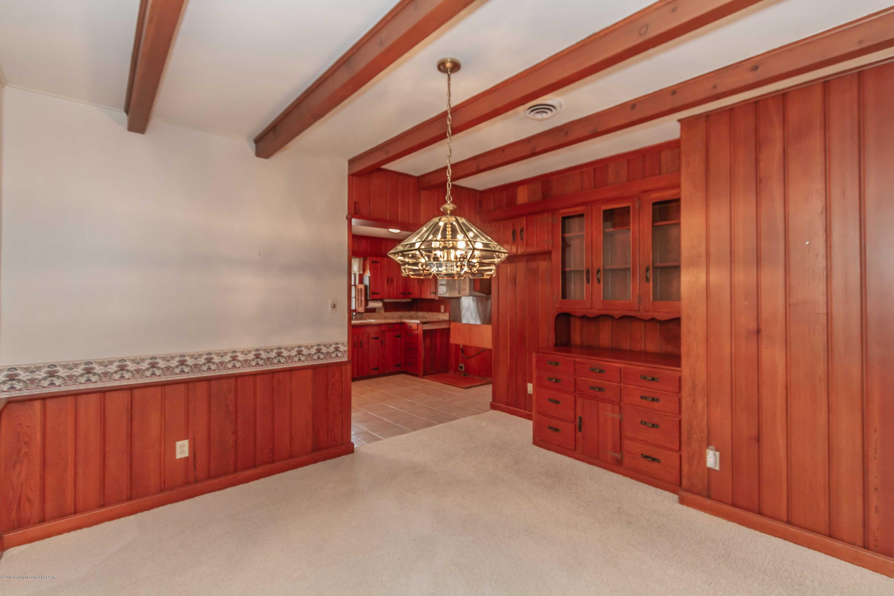 3228 South Travis Street Amarillo, TX 79109 - Photo 13 of 44 a view of a bedroom with cabinet cabinet and mirror