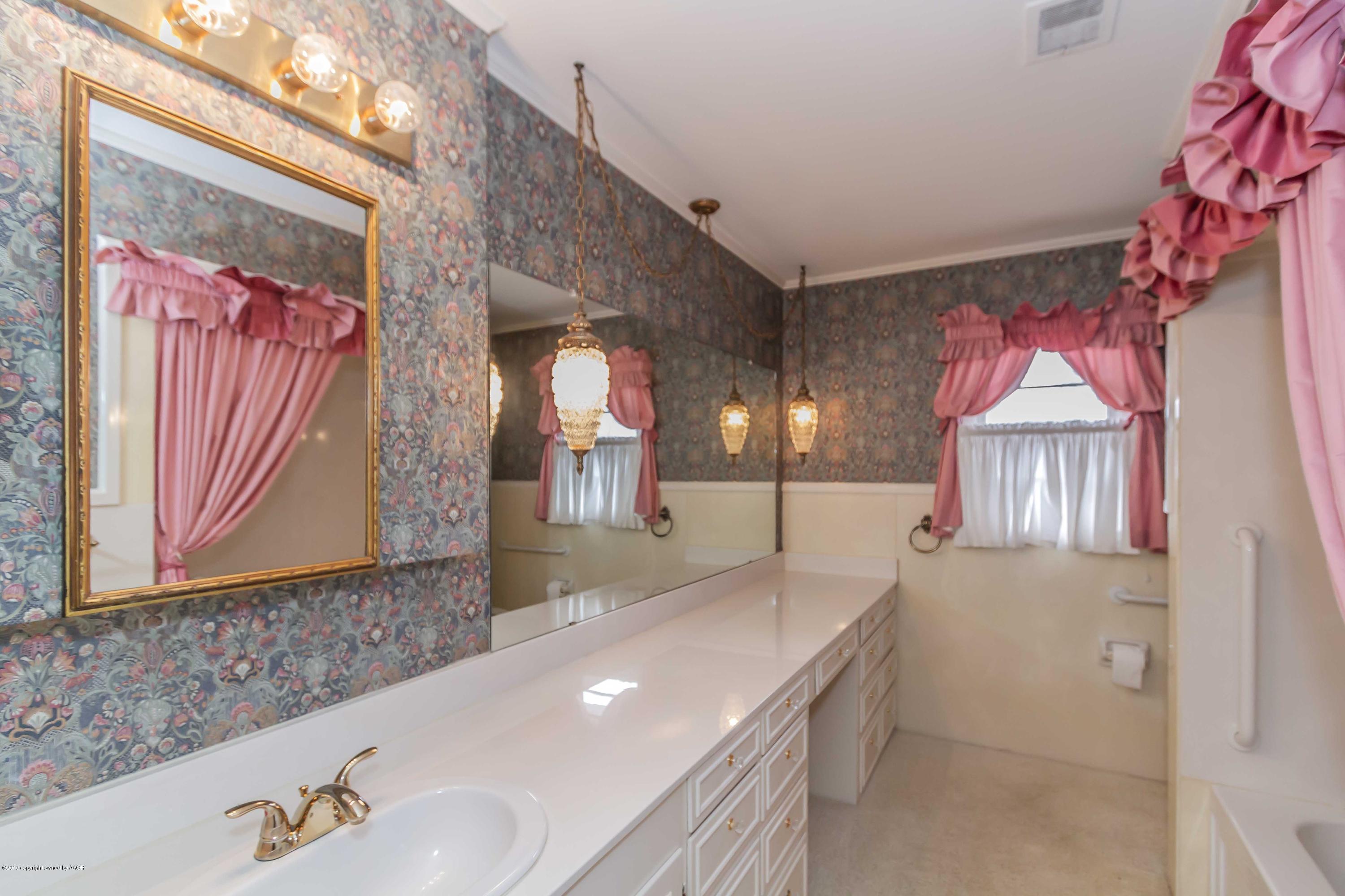 3228 South Travis Street Amarillo, TX 79109 - Photo 35 of 44 a bathroom with a sink a vanity and a mirror