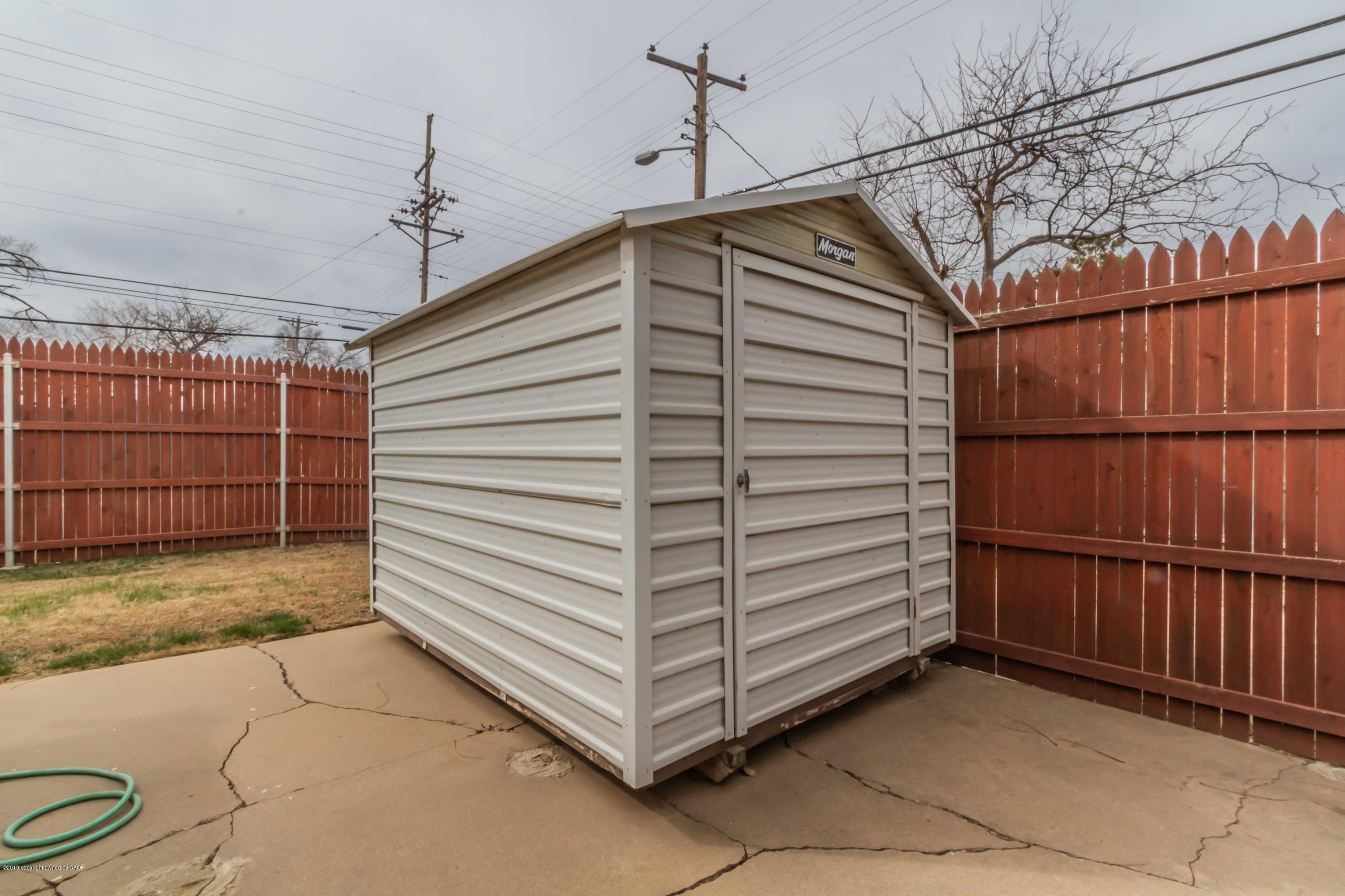 3228 South Travis Street Amarillo, TX 79109 - Photo 43 of 44 a view of a garage with wooden walls