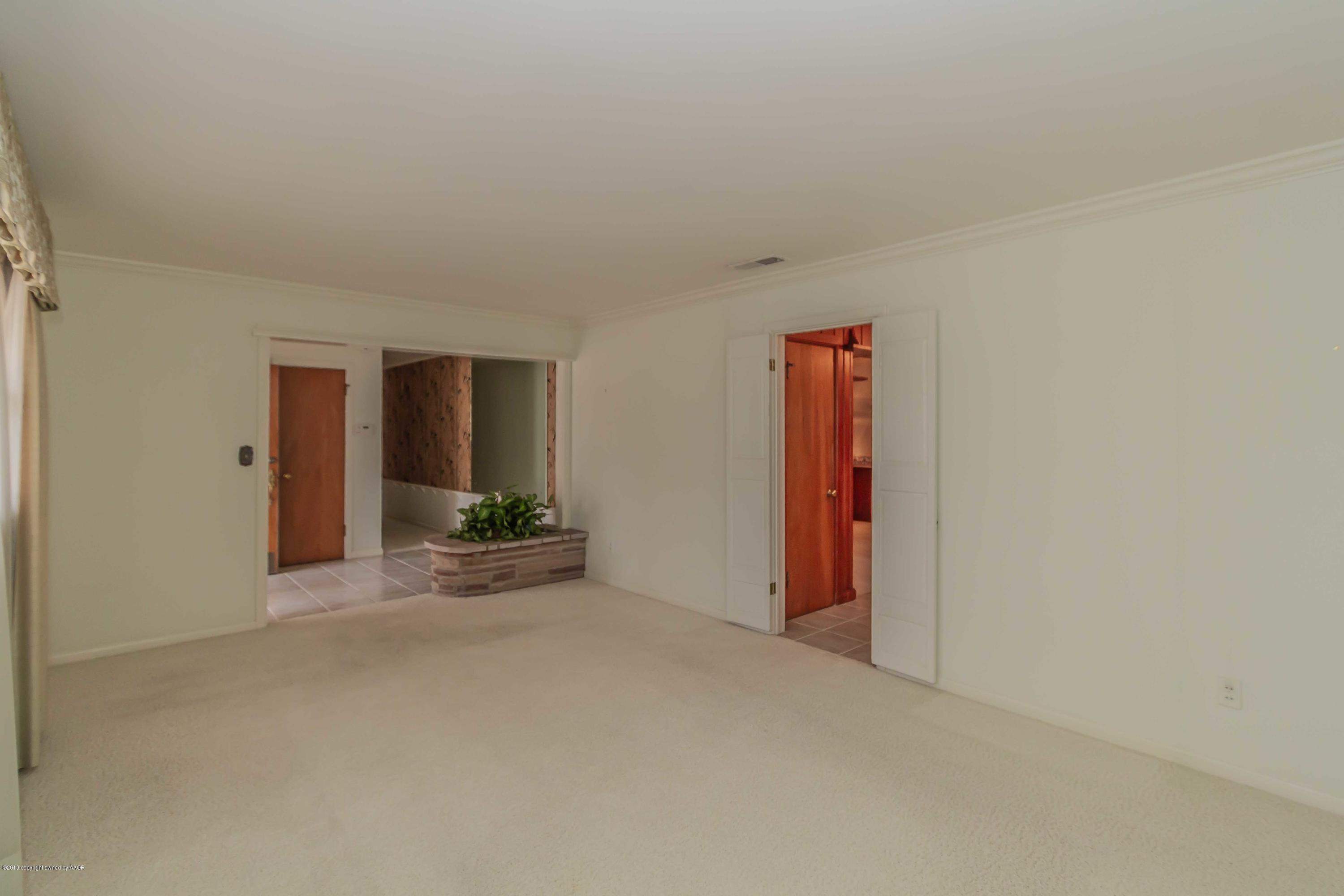 3228 South Travis Street Amarillo, TX 79109 - Photo 7 of 44 a view of an empty room with closet and a window
