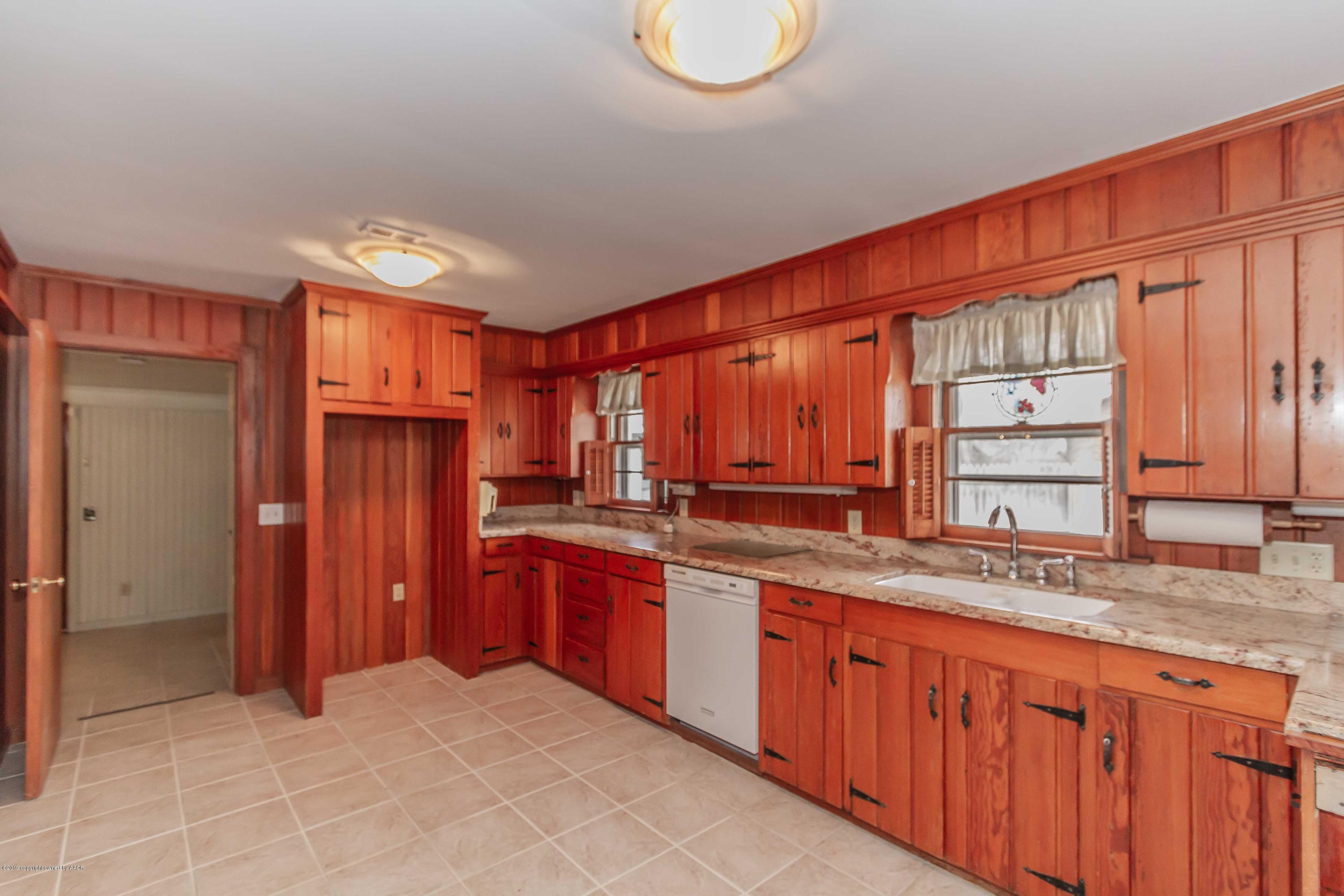 3228 South Travis Street Amarillo, TX 79109 - Photo 8 of 44 a kitchen with stainless steel appliances granite countertop a refrigerator and a sink