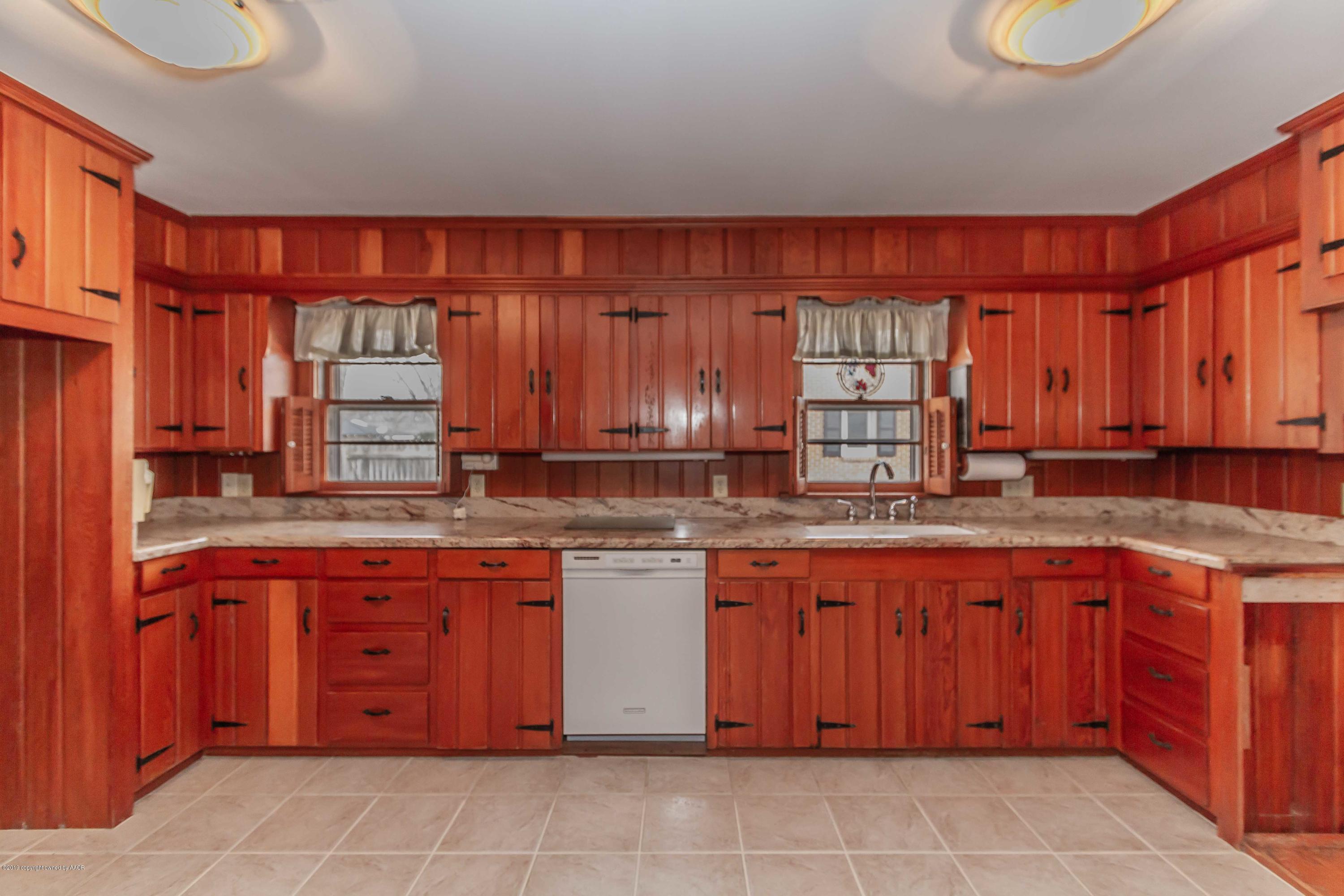 3228 South Travis Street Amarillo, TX 79109 - Photo 9 of 44 a kitchen with a sink and cabinets