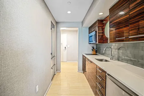 a kitchen with a sink and cabinets