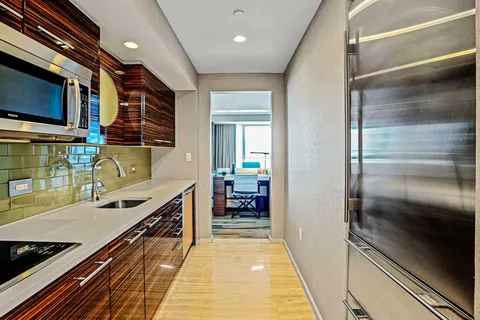 a kitchen with stainless steel appliances granite countertop a refrigerator and a stove