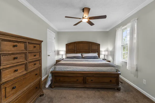 a bedroom with a bed and a chandelier
