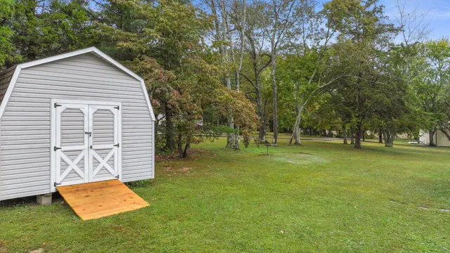 a view of a house with a backyard