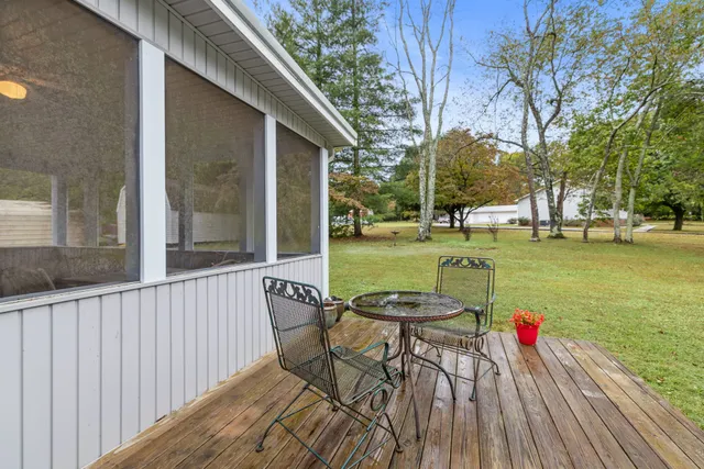 a view of a patio with table and chairs and wooden floor