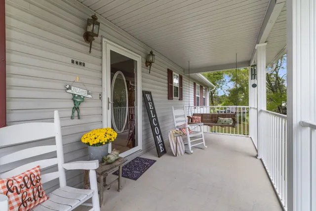 a view of a chairs and table in the balcony