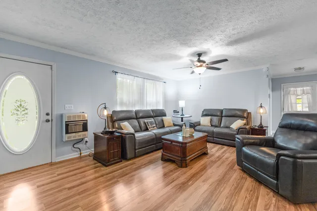 a living room with furniture a fireplace and a window
