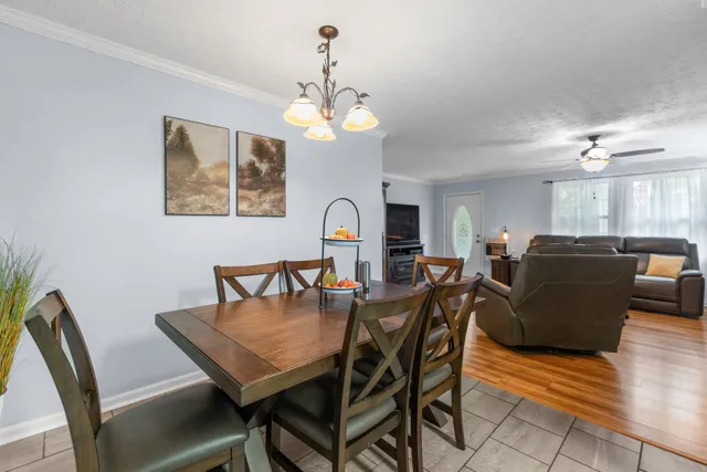 a view of a dining room with furniture and chandelier