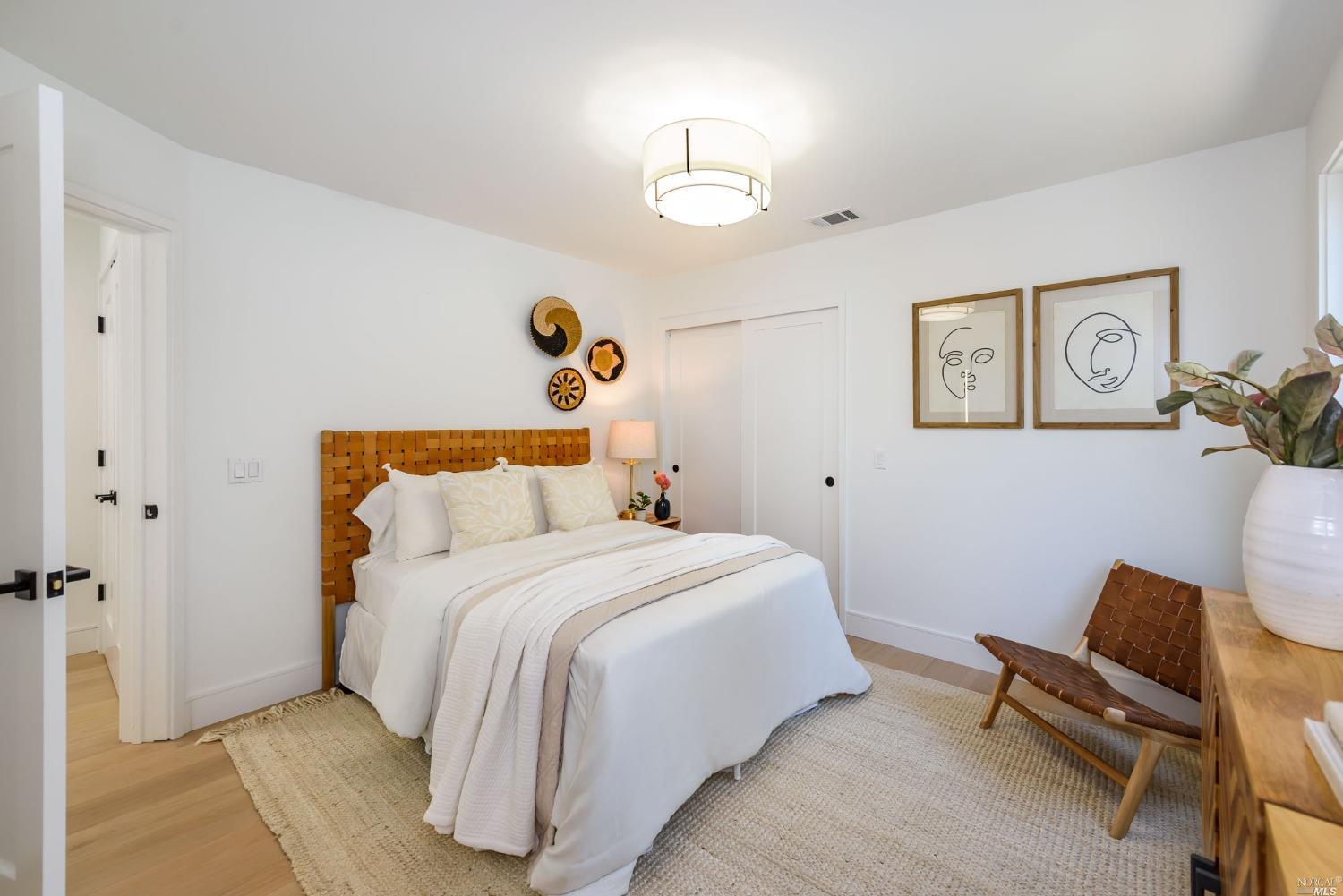 1072 Foster Road Napa, CA 94558 - Photo 16 of 28 a bedroom with a bed and a table in it