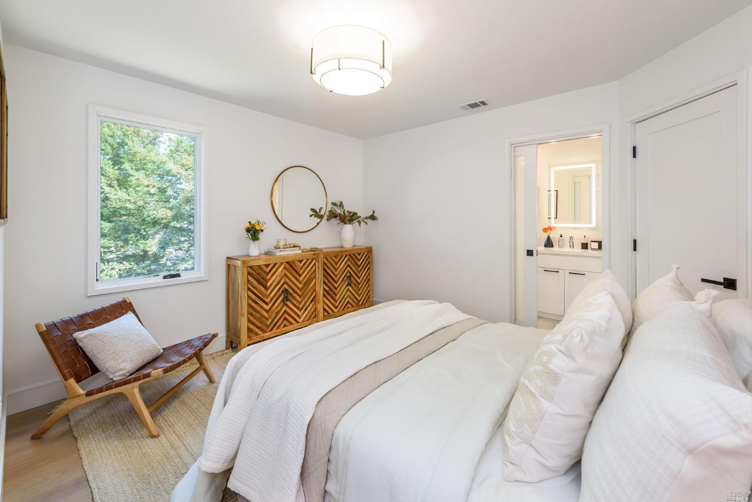 1072 Foster Road Napa, CA 94558 - Photo 17 of 28 a bedroom with a bed a table and chair