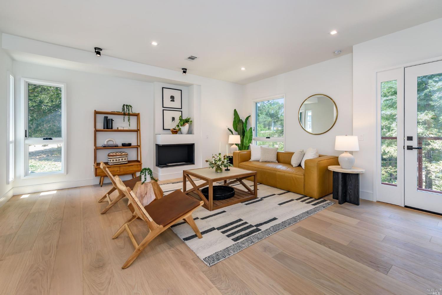 1072 Foster Road Napa, CA 94558 - Photo 8 of 28 a living room with furniture a flat screen tv and a fireplace