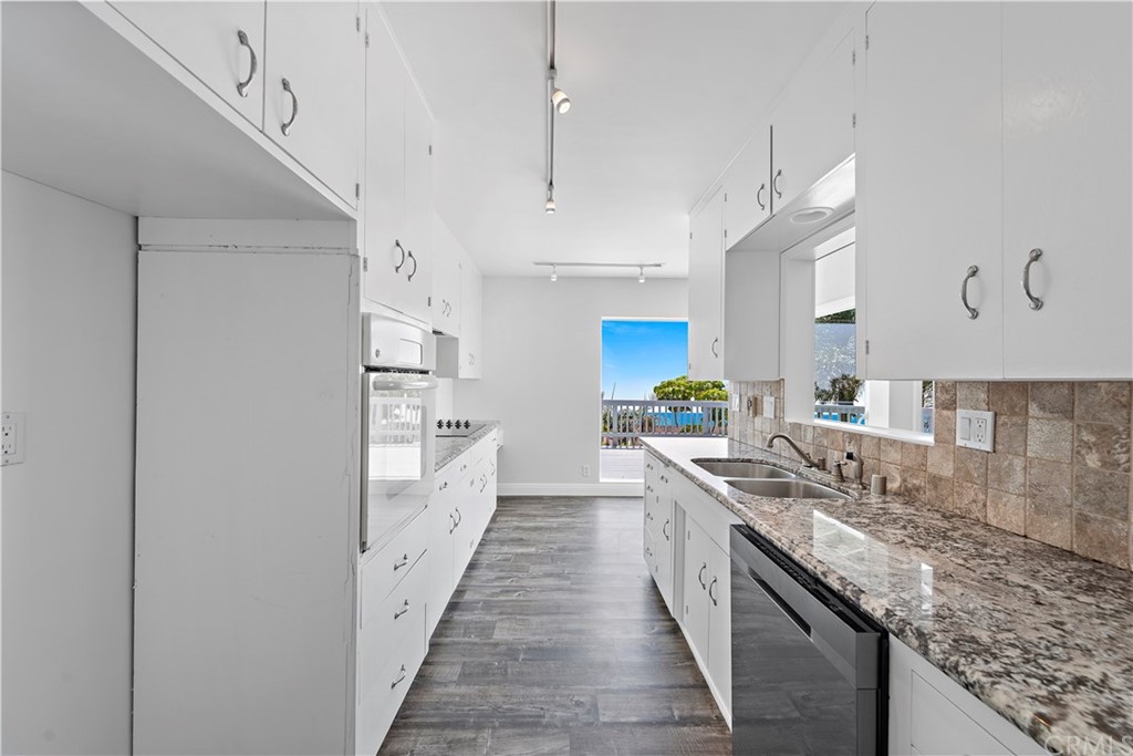2809 Chillon Way Laguna Beach, CA 92651 - Photo 15 of 32 a large kitchen with kitchen island a sink a counter space and stainless steel appliances