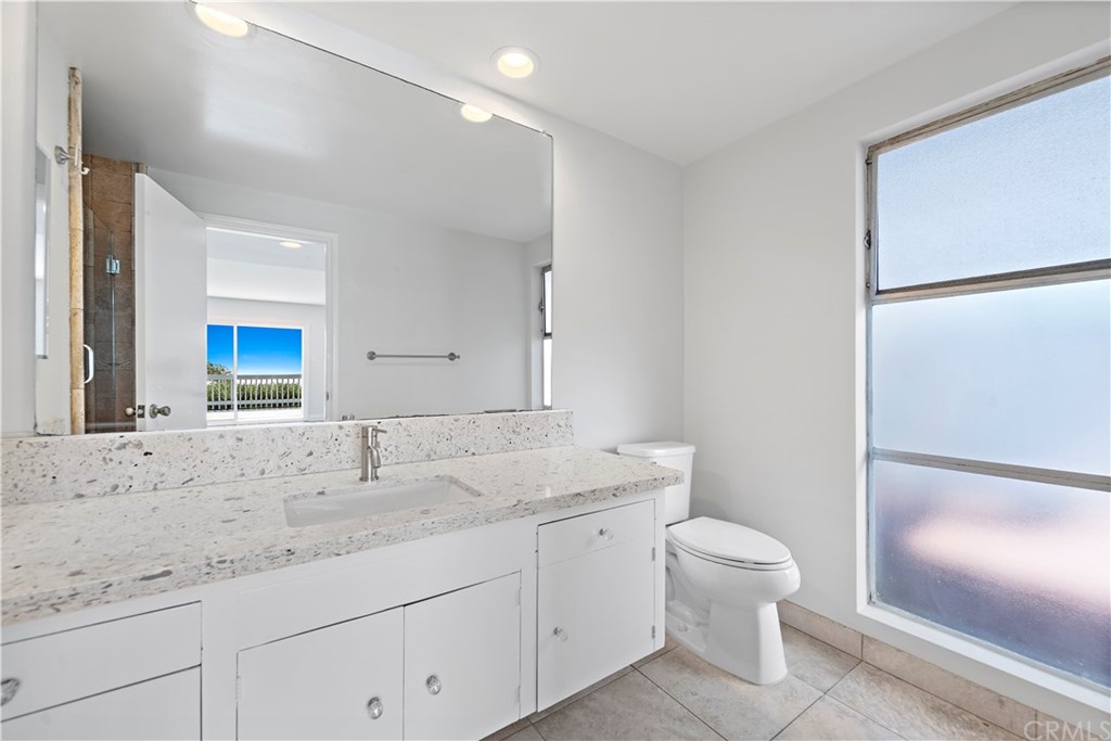 2809 Chillon Way Laguna Beach, CA 92651 - Photo 19 of 32 a bathroom with a granite countertop sink toilet and shower