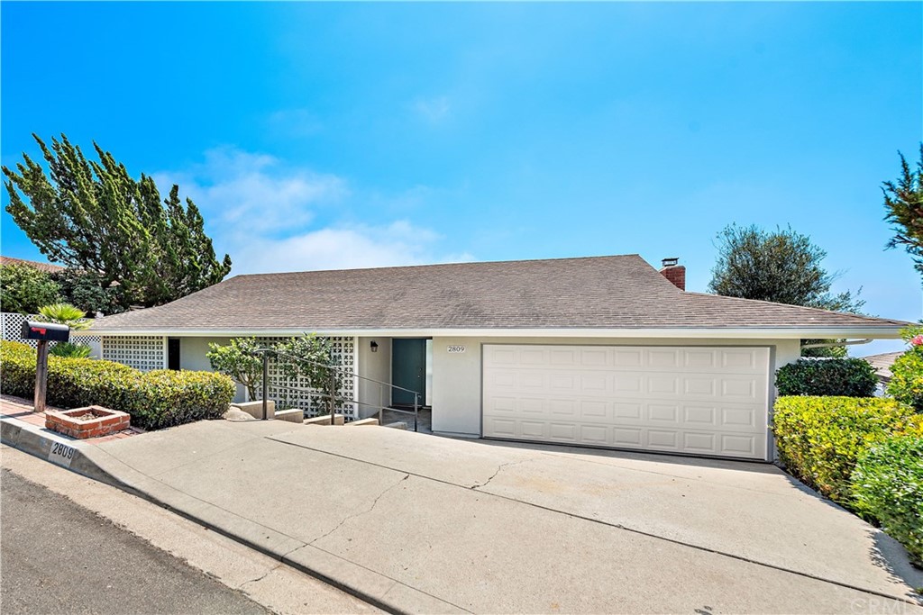 2809 Chillon Way Laguna Beach, CA 92651 - Photo 3 of 32 a front view of a house with a yard and garage