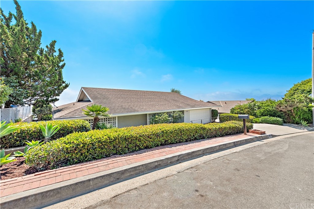 2809 Chillon Way Laguna Beach, CA 92651 - Photo 4 of 32 a front view of a house with a yard and potted plants