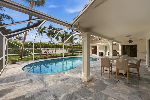 an aerial view of a house with a swimming pool