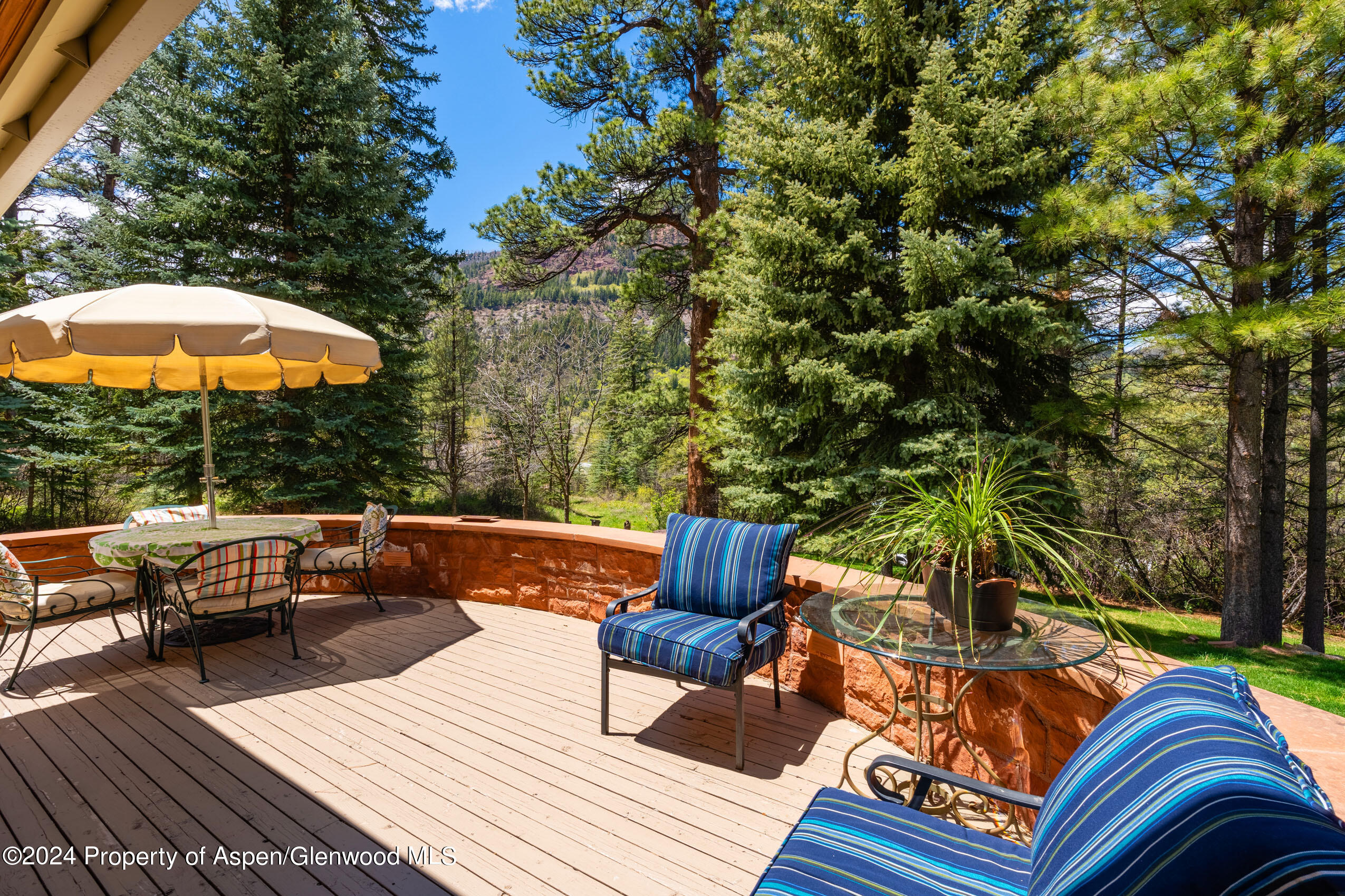102 Firehouse Road Redstone, CO 81623 - Photo 25 of 50 an outdoor sitting area with furniture and wooden floor