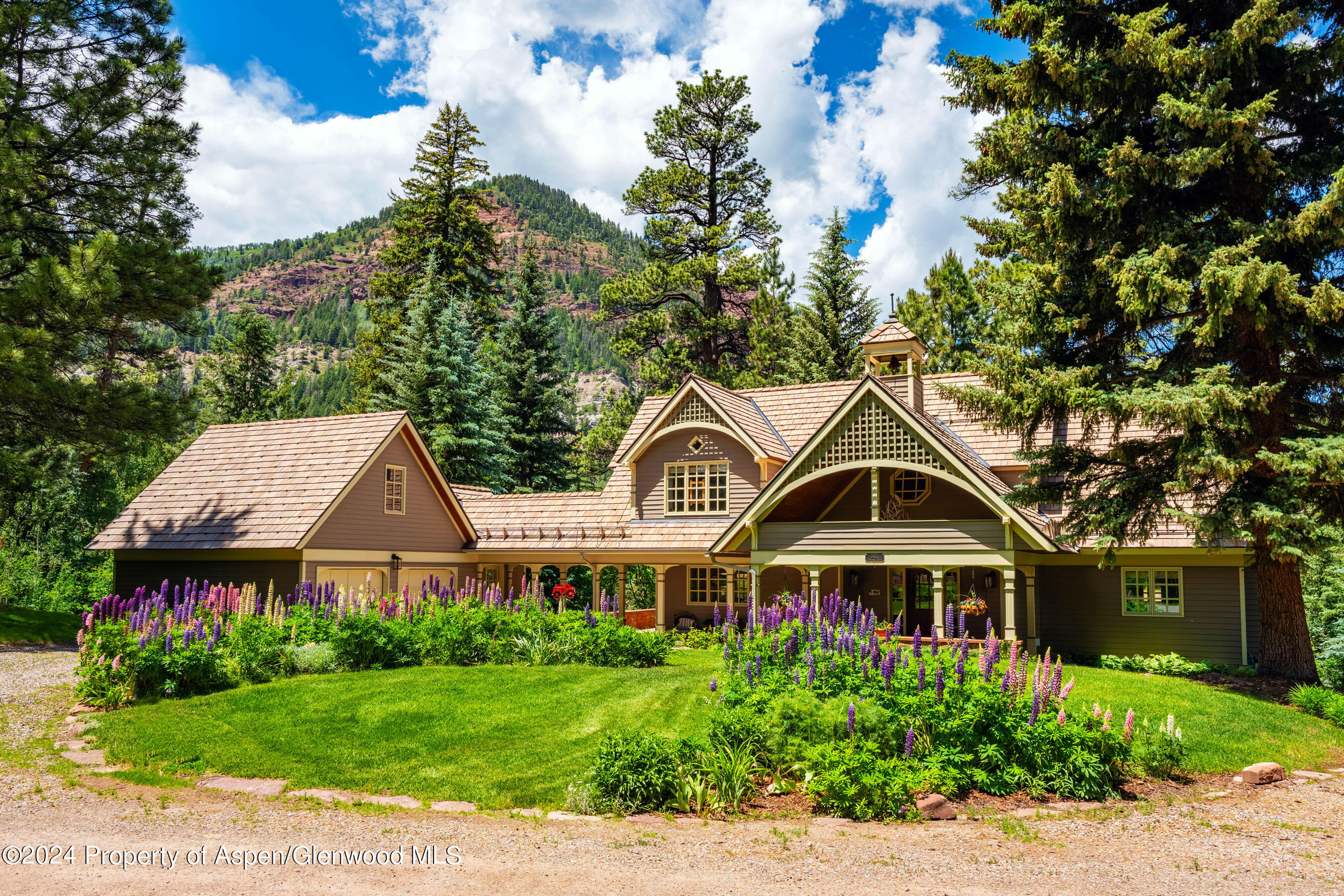 102 Firehouse Road Redstone, CO 81623 - Photo 7 of 50 a view of a white house with a big yard and large trees