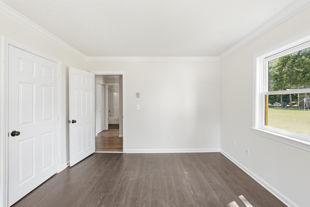30 Abbey Road, Unit 102 Leominster, MA 01453 - Photo 11 of 15 an empty room with wooden floor and windows