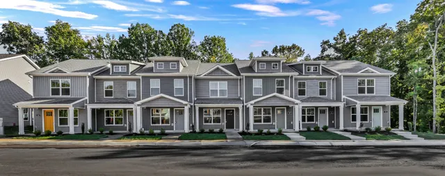a front view of a residential apartment building with a yard
