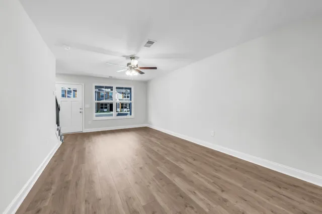wooden floor in an empty room with a window