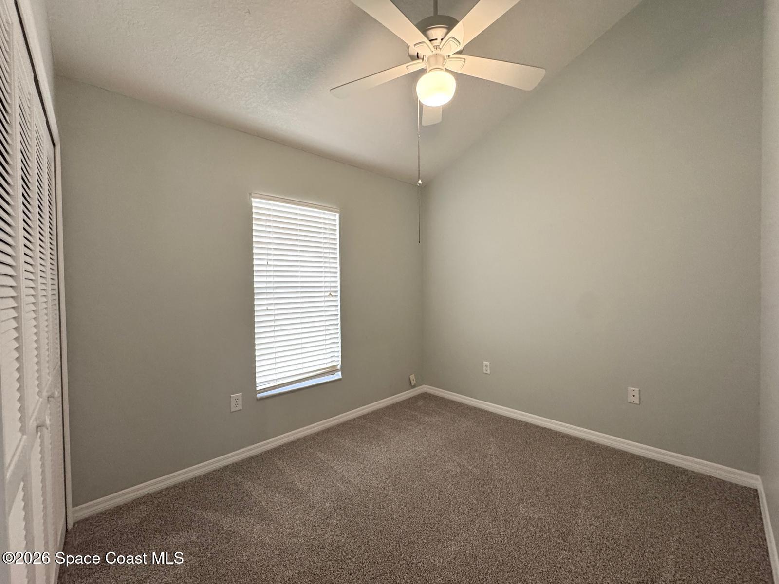 2168 Misty Way Lane Melbourne, FL 32935 - Photo 15 of 19 an empty room with a window and a fan